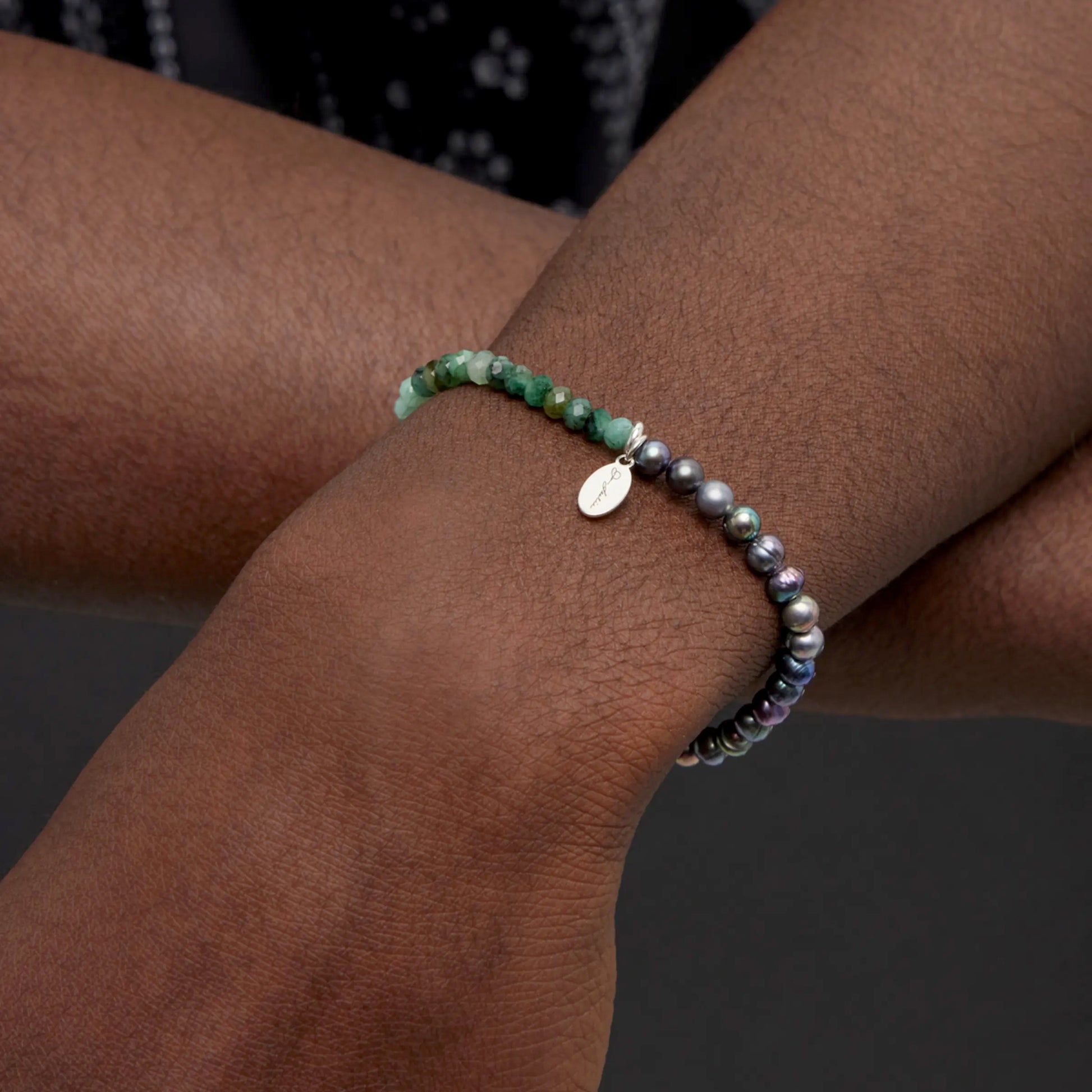 Male model wearing the Green Emerald and Freshwater Pearls Split Beaded Bracelet by Jan Leslie of NYC.