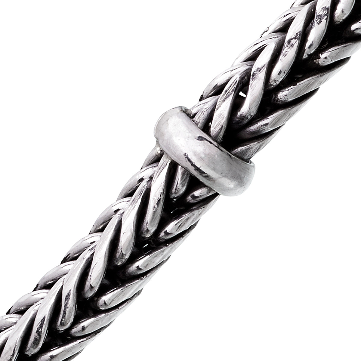Close-up of oxidized sterling silver heavy braided wheat chain bracelet with smooth ring accent by Jan Leslie.