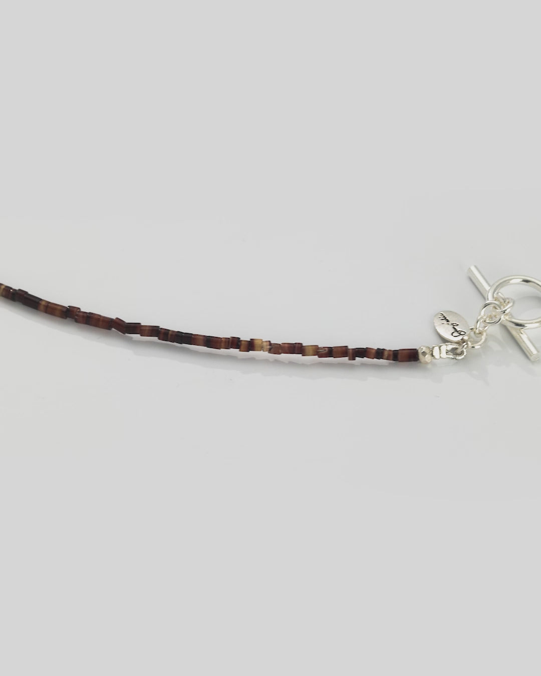 Video of a 360 degree view of the Freshwater Pearl Center Chocolate Shell Beaded Necklace with Sterling Silver Accents.