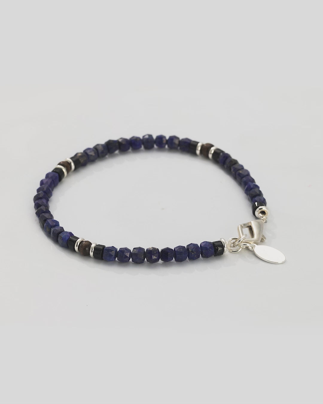 360 video of the Lapis Bead Bracelet with Wood and Sterling Silver Spacers and Lobster Closure. Video shows full bracelet and closeup of lapis beads, wood, and sterling silver spacers.