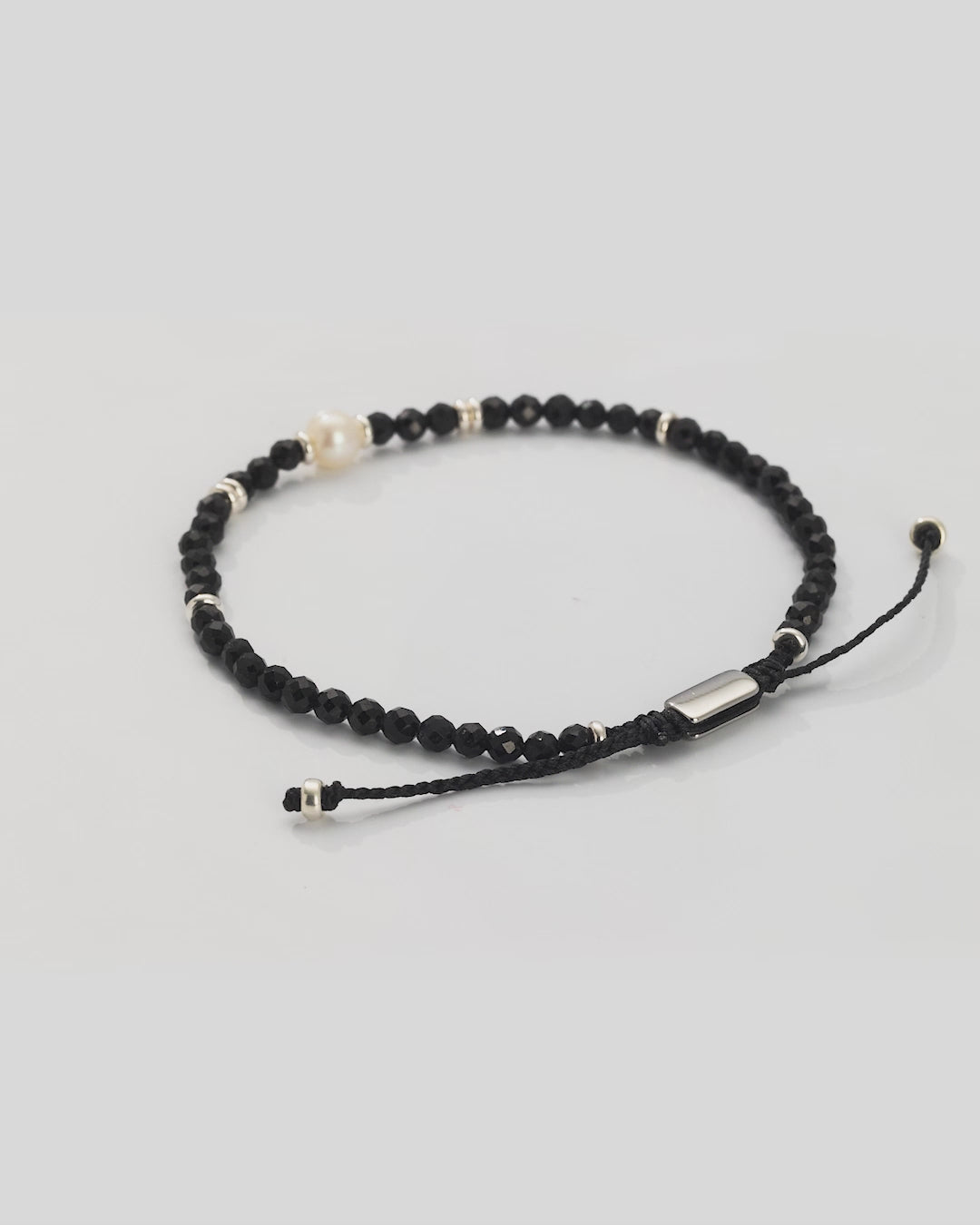360 video of the Men's Black Onyx Beaded Bracelet with Freshwater Pearl Center. Video shows the full bracelet and close up of the freshwater pearl center and sterling silver spacers.