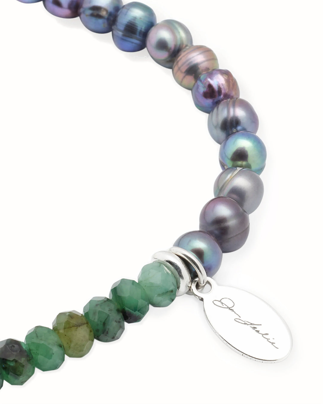 Close up of the faceted emerald beads, freshwater pearls, and sterling silver spacer.