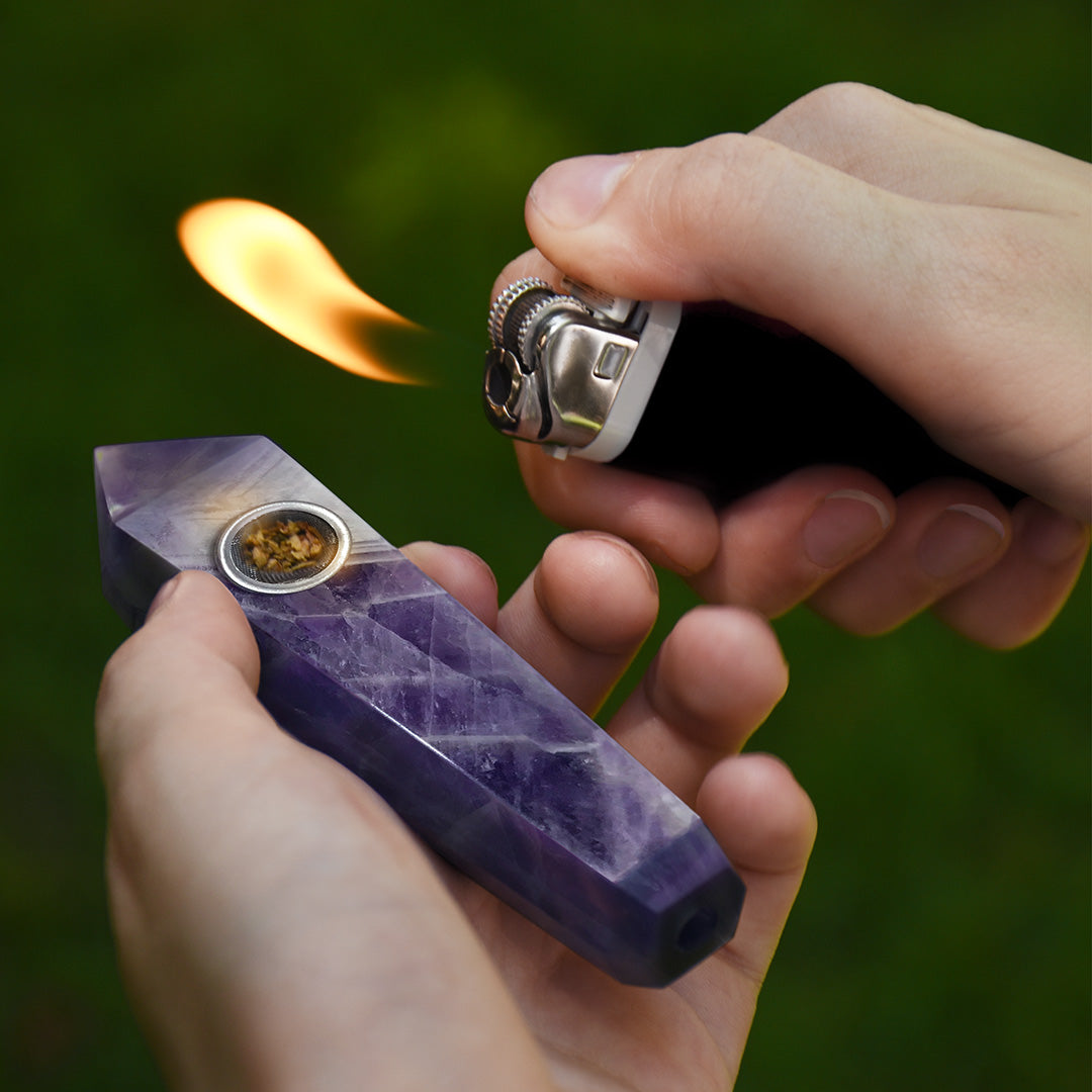 Picture of model lighting up the Dream Amethyst Pipe - The Peace Stone with black lighter.