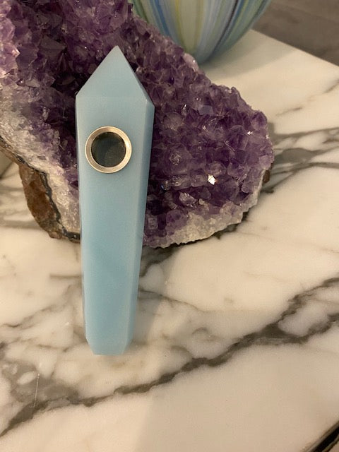Blue Quartz Gemstone Pipe - The Joyful Stone displayed on an amethyst gemstone and marble.