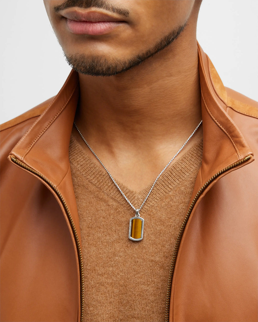 Close up of male model wearing the Tiger's Eye Gemstone Plaque Sterling Silver Pendant Necklace.