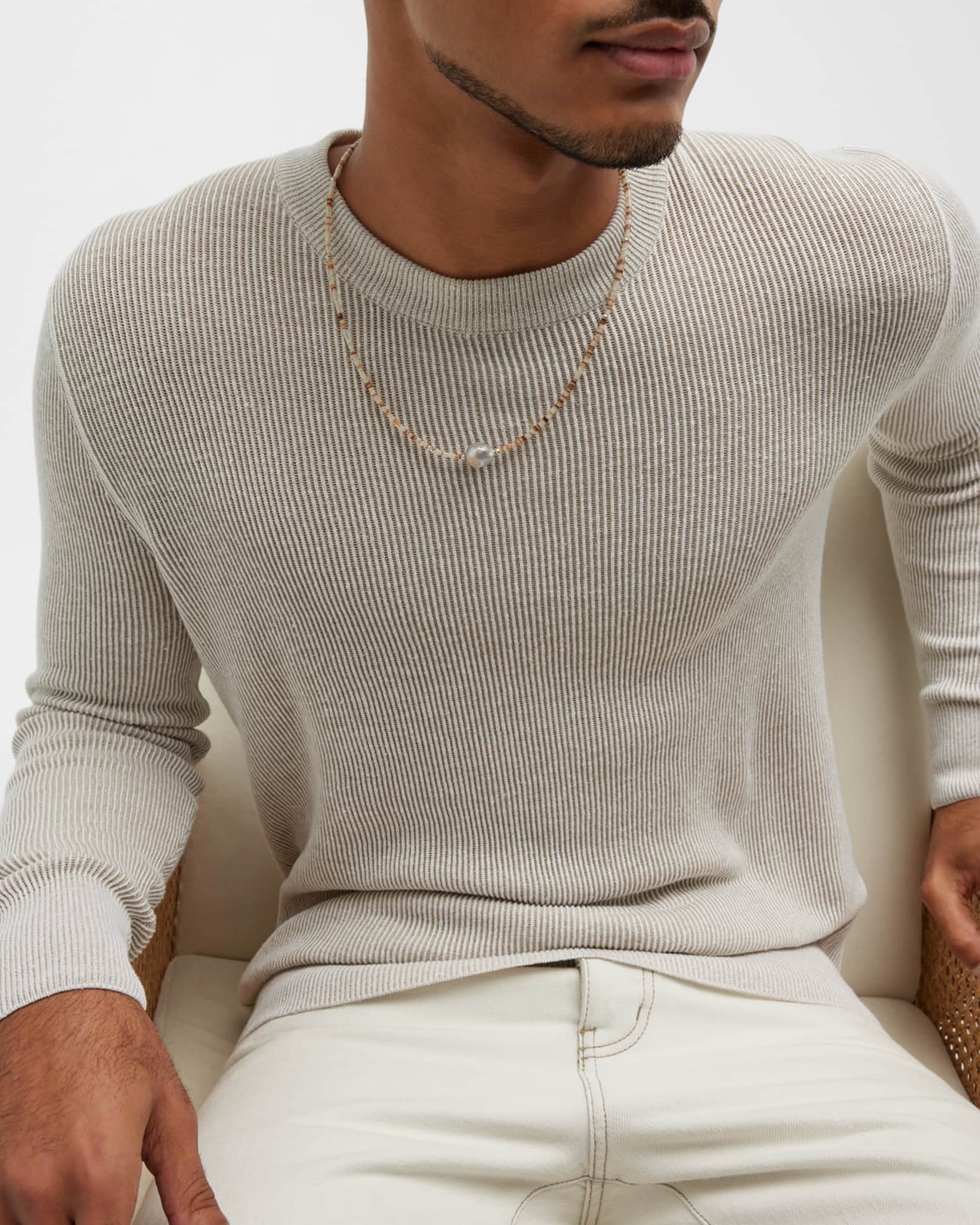 Photo of seated male models torso showing off the Freshwater Pearl Center White Shell Beaded Necklace with Sterling Silver Accents.