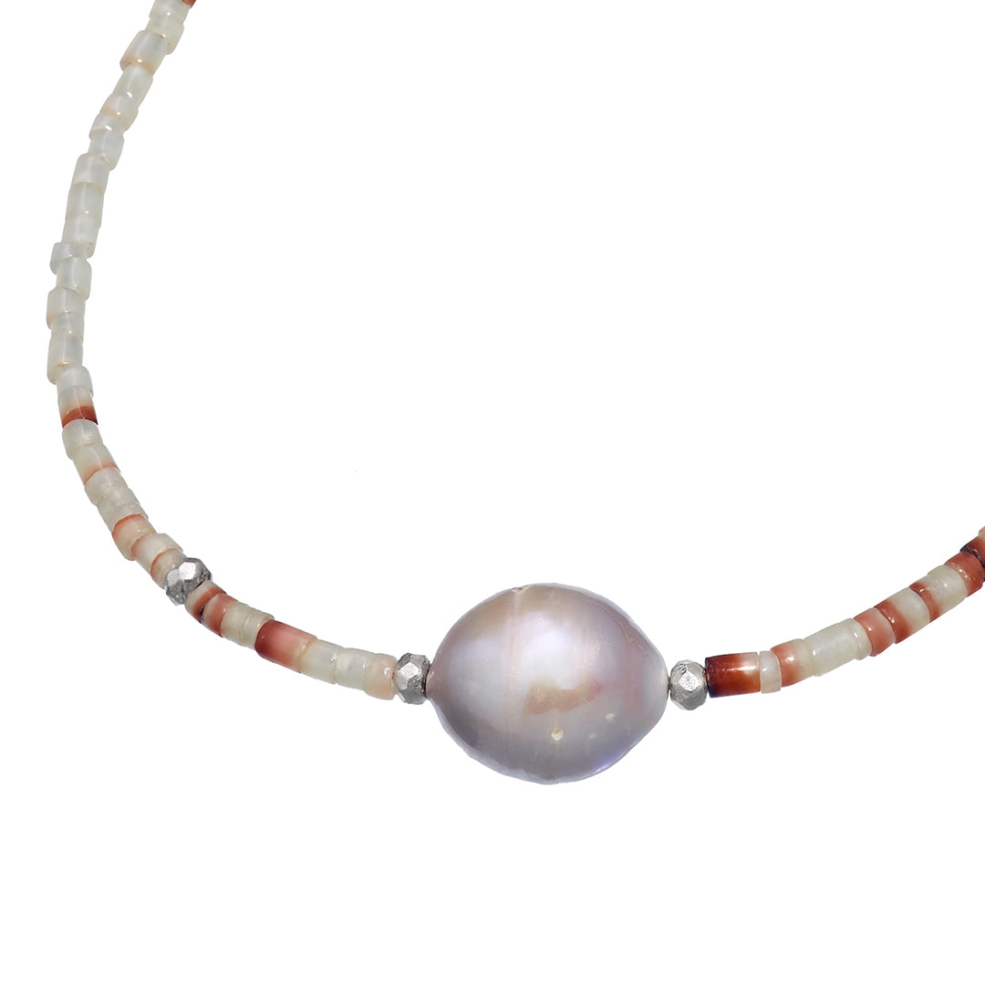 Close up photo showing the grey freshwater pearl, sterling silver faceted beads and white shell beads on the Freshwater Pearl Center White Shell Beaded Necklace with Sterling Silver Accents.