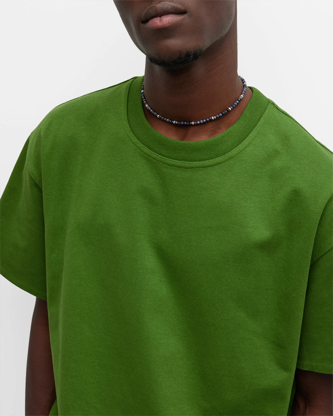 Torso view of male model wearing the Blue Sapphire Beaded Necklace with Sterling Silver Accents and Toggle Closure. Jan Leslie Cufflinks and Accessories.