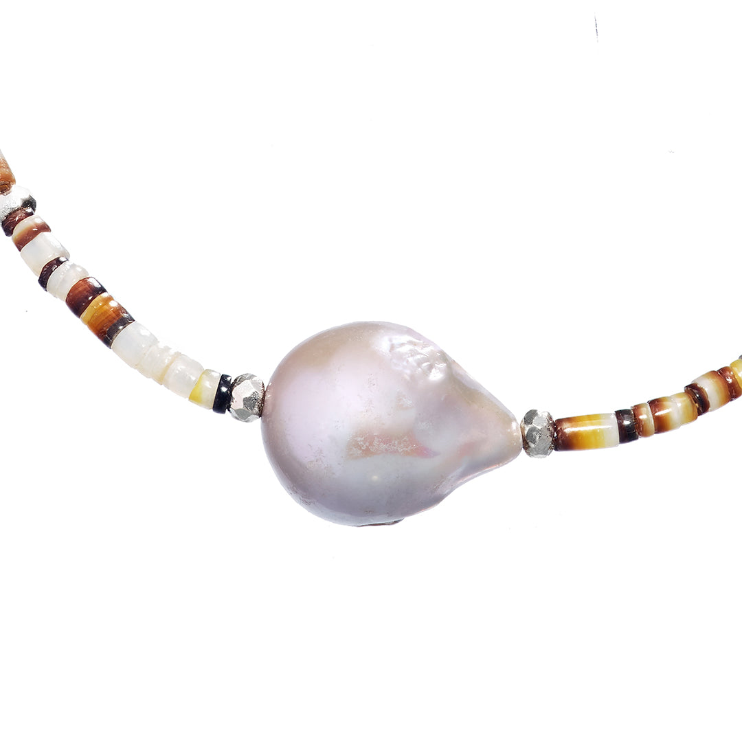 Close up of the freshwater pearl and sterling silver accents on the Shell Beaded Necklace with Freshwater Pearl Center and Sterling Silver Accents.
