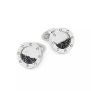 Sterling silver round porthole cufflink with loose black diamond crystals floating in glass dome and screw-detail bezel showing bullet-back closure by Jan Leslie.
