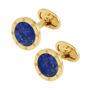 A pair of gold cufflinks with circular blue lapis lazuli stone inlays.