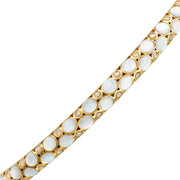 Gold vermeil white mother-of-pearl and champagne glitter bubble bangle bracelet close-up showing iridescent MOP and glitter cabochon pattern on polished gold vermeil bangle by Jan Leslie
