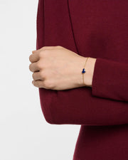 Model wearing blue lapis heart station bracelet on gold cable chain — Jan Leslie"