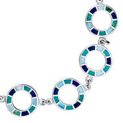 Close-up of sterling silver open circle links with cobalt teal and sky blue enamel mosaic tile segments by Jan Leslie.