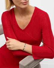 Model in red knit dress wearing green malachite heart link gold bracelet — Jan Leslie