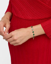Model in red knit dress wearing green malachite heart link gold bracelet — Jan Leslie
