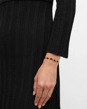 Red tiger's eye bezel heart link gold bracelet draped, angled studio view — Jan Leslie