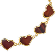 Close-up of red tiger's eye bezel heart links on gold chain bracelet — Jan Leslie