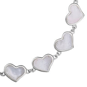 Close-up of white mother-of-pearl bezel heart link sterling silver bracelet — Jan Leslie