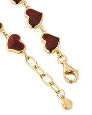 Close-up of red tiger's eye bezel heart links on gold chain bracelet — Jan Leslie