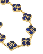 Close-up macro detail of gold vermeil sterling silver multi-station lapis lazuli floral lattice quatrefoil bracelet showing deep royal blue stone inlay with gold curved petal overlay on bezel-set stations and rolo chain links, Jan Leslie