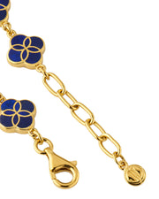 Close-up of gold vermeil lobster clasp, paperclip extender chain, and engraved JL Jan Leslie signature disc charm on lapis lazuli floral lattice quatrefoil bracelet.