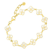 Close-up detail of gold vermeil sterling silver multi-station lapis lazuli floral lattice quatrefoil bracelet showing deep blue stone inlay petal stations, gold lobster clasp, paperclip extender chain, and engraved JL Jan Leslie