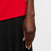 Model wearing multi-gemstone gold vermeil station bracelet with carnelian, tiger's eye, and lapis lazuli on wrist by Jan Leslie.