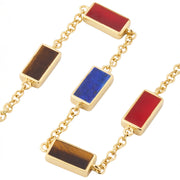  Flat lay detail of gold vermeil bracelet showing carnelian, lapis lazuli, and tiger's eye rectangular gemstone stations by Jan Leslie.