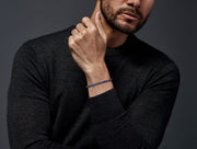 Royal blue lapis lazuli cylinder and oxidized sterling silver disc rondelle stretch bracelet worn on wrist 
