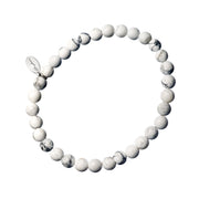 White howlite rounds with natural grey veining, a single sterling silver engraved rondelle spacer, and a Jan Leslie oval signature charm tag