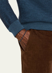  Man wearing blue sapphire faceted round bead bracelet with gold vermeil spacers on wrist with teal ribbed knit sweater and brown corduroy trousers by Jan Leslie