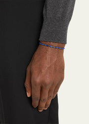  Man wearing lapis lazuli heishi cylinder bead bracelet with gold vermeil spacers on wrist with grey merino sweater and black trousers by Jan Leslie