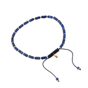  Lapis lazuli heishi cylinder bead bracelet with gold vermeil spacers angled view showing black macramé cord knot Jan Leslie gold tag and lapis cylinder bead detail by Jan Leslie