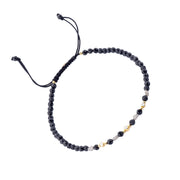 Black onyx beaded adjustable bracelet with gold and diamond accent beads.