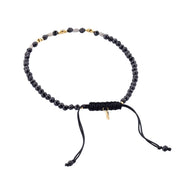 Black onyx beaded bracelet with rough diamond and gold accents, adjustable.