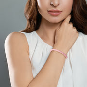 Model wearing blush pink braided leather bracelet with gold vermeil magnetic clasp on wrist by Jan Leslie.