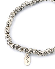 Silver-plated lava stone bead stretch bracelet with oxidized pitted texture and oval Jan Leslie script charm pendant
