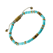 Turquoise heishi bead bracelet with antique brass spacers and adjustable cord closure, Jan Leslie