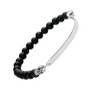 Men's matte black onyx bead bracelet with sterling silver ID bar and sculpted skull connectors