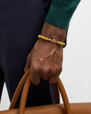 Men's yellow agate bead bracelet with sterling silver oval bezel centerpiece styled with navy suit and teal knit sweater, Jan Leslie
