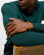 Men's yellow agate bead bracelet with sterling silver oval bezel centerpiece styled with navy suit and teal knit sweater, Jan Leslie