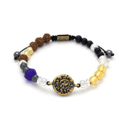 Adjustable multi-gemstone bracelet with antique brass coin centerpiece, rudraksha seeds, blue glass lotus, and mixed gemstone beads, Jan Leslie