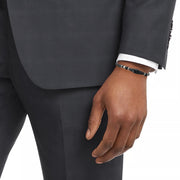 Men's black onyx bead bracelet with Tibetan dzi agate centerpiece styled with charcoal suit and white dress shirt, Jan Leslie
