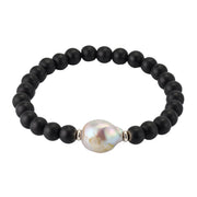 Men's black onyx stretch bracelet with baroque freshwater pearl centerpiece and sterling silver rondelle spacers.Jan Leslie.