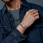 Oxidized gunmetal twisted cable cuff bracelet styled with denim jacket and black bead necklace, Jan Leslie