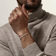 Polished sterling silver twisted cable cuff bracelet styled with grey cashmere turtleneck, Jan Leslie