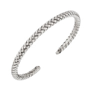 Oxidized sterling silver wide herringbone woven open cuff bracelet with dark antiqued finish, close-up angled view.