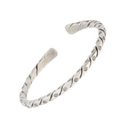  Sterling silver oxidized twisted rope open cuff bracelet three-quarter view showing full helical twist silhouette and engraved daisy dot station detail by Jan Leslie