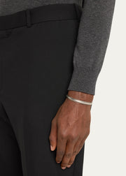 Man wearing sterling silver oxidized rope-edge triple-channel open cuff bracelet on wrist with grey merino sweater and black trousers by Jan Leslie